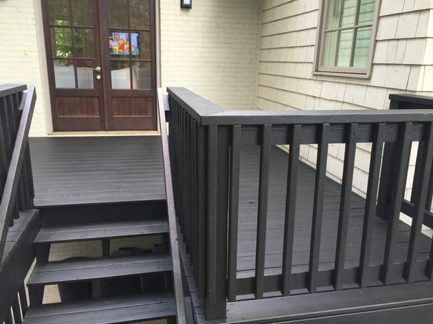Deck restoration expert consultation in Birmingham, AL. Alabama Deck Restoration, owner of Alabama Deck Restoration, discussing repair options with a homeowner on a porch.