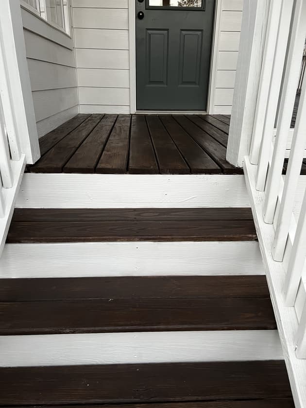 Deck sealing services being performed on a treated wooden deck